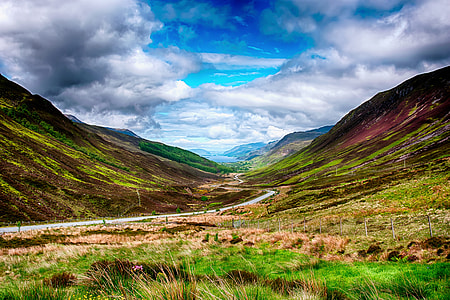 landscape photography of winding road between mountains during daytime thumbnail