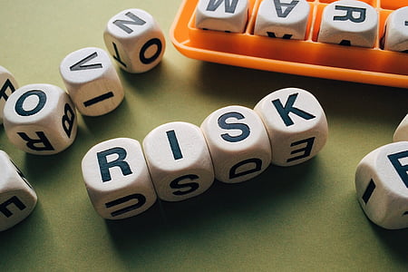 four white-and-black risk letter dices thumbnail