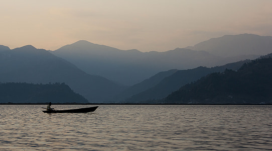 person riding boat sailing on body of water during dawn thumbnail
