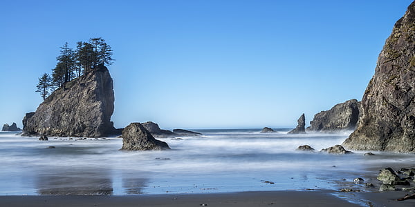 gray stones in sea at daytime thumbnail