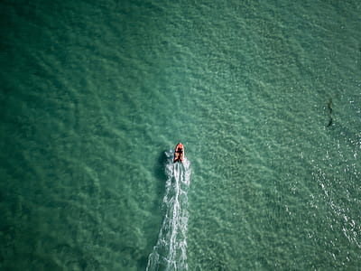 bird's eye view of red and white personal watercraft thumbnail
