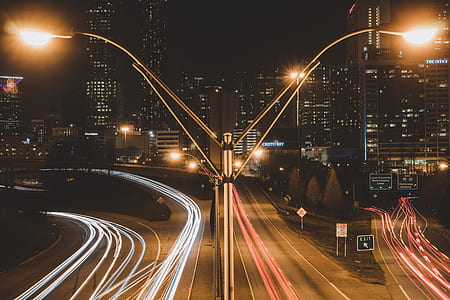time lapse photo of vehicle passing through road thumbnail