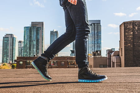 person wearing black-and-blue LED high-top sneakers thumbnail