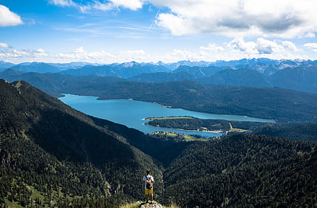 man standing on mountain during daytime thumbnail