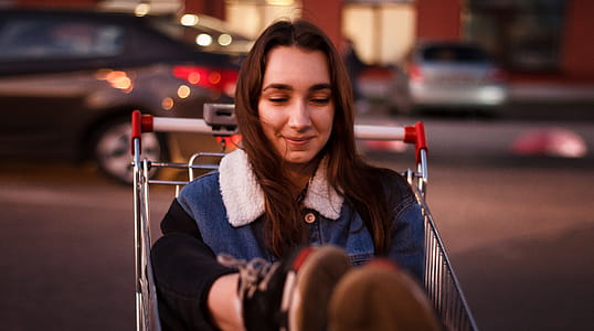 Close-Up Photo of Woman Riding Shopping Cart thumbnail