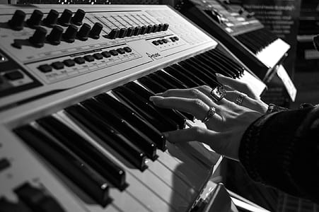 Person Playing Electric Piano in Grayscale Photo thumbnail