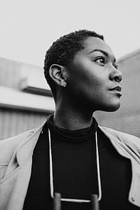 grayscale photography of standing near grey wall thumbnail