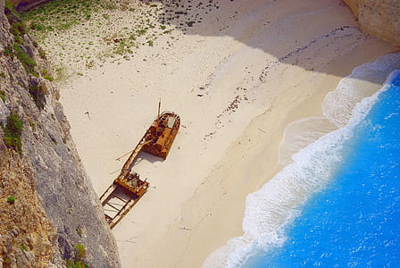 photo of wrecked boat near shore thumbnail