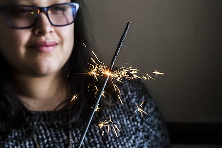 closeup photo of woman holding sparkler thumbnail