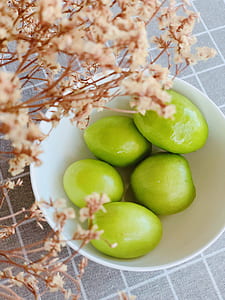 five green fruits in white ceramic bowl thumbnail
