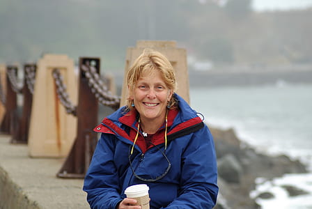 woman wearing blue full-zip jacket thumbnail