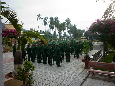 military standing near building at daytime thumbnail