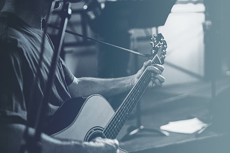 grayscale photo of person playing guitar thumbnail