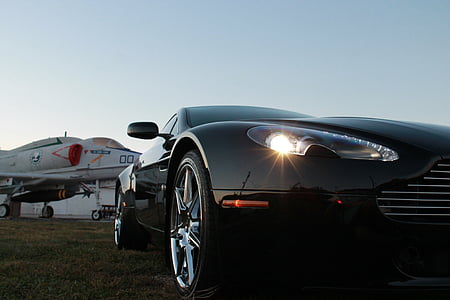 parked black car near plane thumbnail