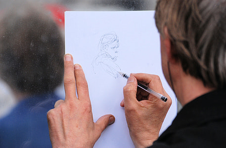 person sketching a girl on white paper thumbnail