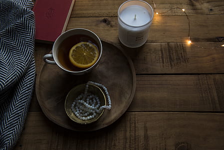 votive candle beside tea cup thumbnail