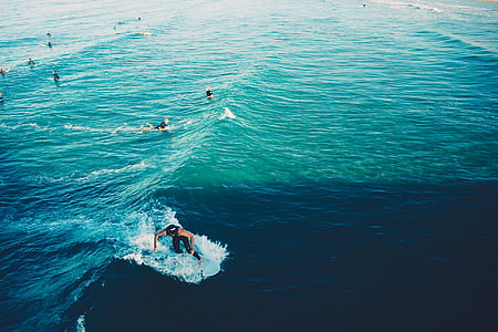 person using surfboard during daytime thumbnail