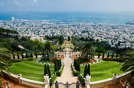 Panoramic View of Hedge and Raw Houses Across Large Body of Water thumbnail