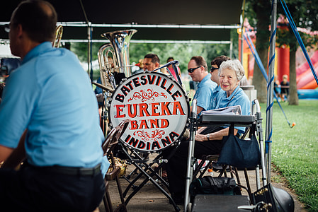 woman sitting beside Eureka Band signage thumbnail