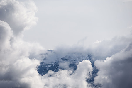 white clouds over black and white mountain thumbnail