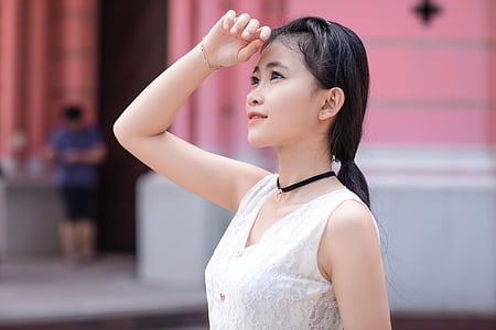 woman wearing white top and black choke necklace thumbnail