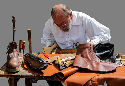 man holding shoe tree in front of shoes thumbnail