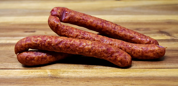 sausages on wooden board thumbnail