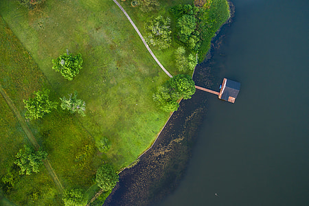 black house near green grass field aerial view thumbnail