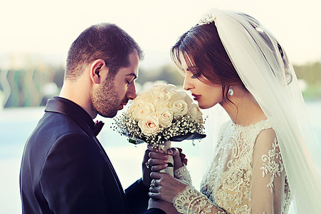 photography of man and woman kissing white flowers thumbnail