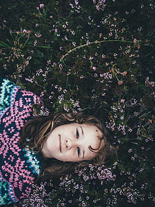 girl laying on green grassfield thumbnail
