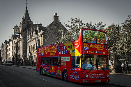 red and yellow double decker bus on concrete road thumbnail
