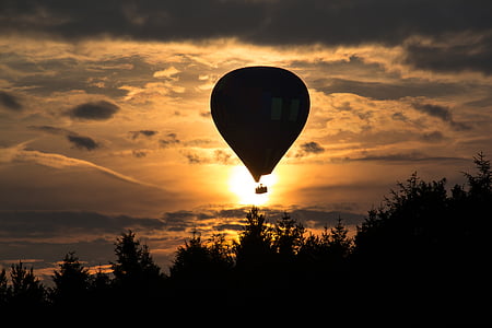 silhouette of hot air balloon during golden hour thumbnail