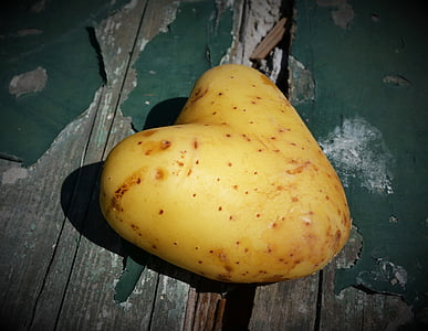 heart-shaped potato on green surface thumbnail