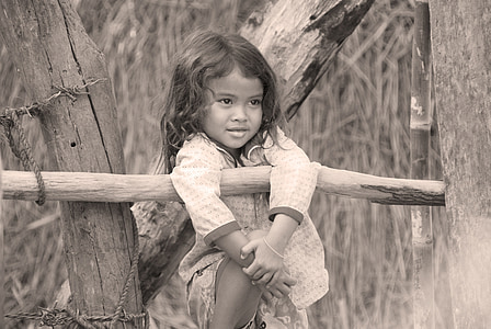 grayscale photo of girl beside log thumbnail