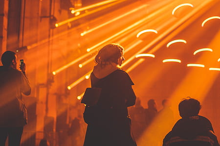 woman near rays of orange lights thumbnail