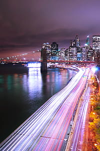 low exposure photo of vehicles on road during night time thumbnail