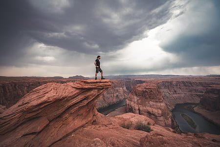 man standing on cliff rock at Colorado Horseshoe Bend thumbnail