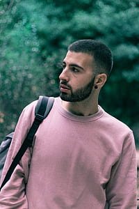 man looking at his right near trees during day thumbnail