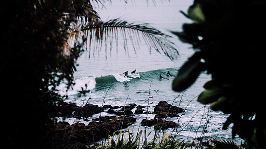 people surfing on seawaves at daytime thumbnail