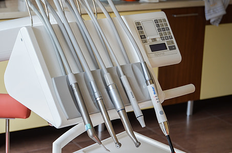 photo of white and gray dentistry machine with corded tools thumbnail