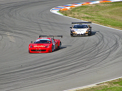 two white and red racing cars on road during daytime thumbnail