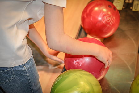 person holding bowling ball thumbnail