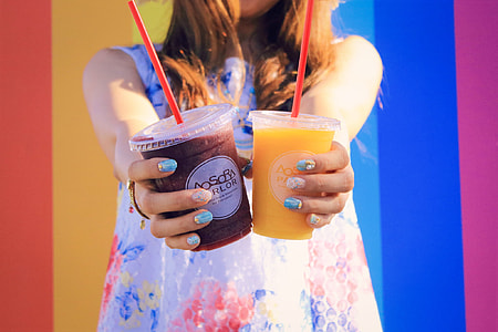 woman holding plastic cups thumbnail