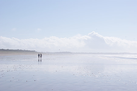 silhouette of couple walking in the sea thumbnail