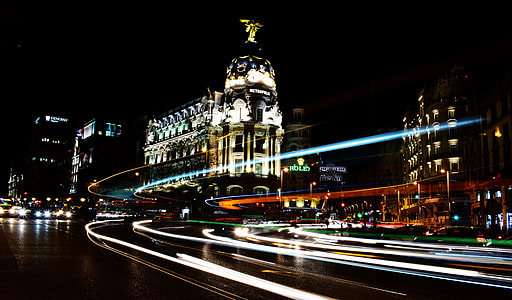 timelapse photo of roadway and building during nighttime thumbnail