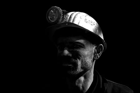 grayscale photo of man wearing hard hat thumbnail