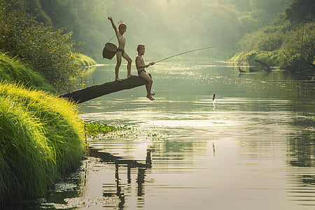 two boys fishing in a river thumbnail