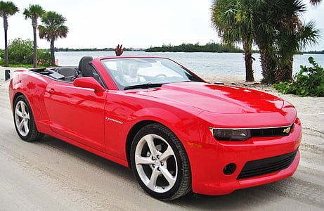 red Chevrolet convertible Camaro near body of water thumbnail