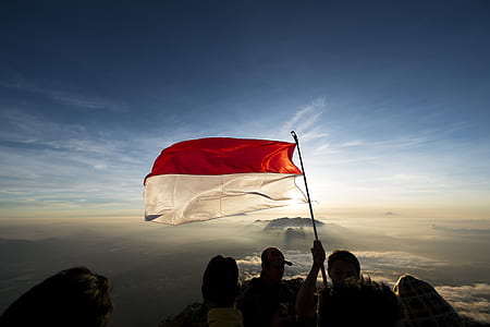 person holding red and white banner thumbnail