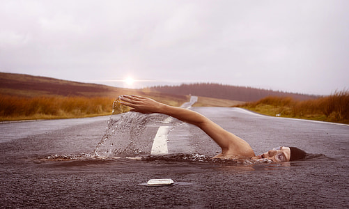 Man swimming across the river road thumbnail
